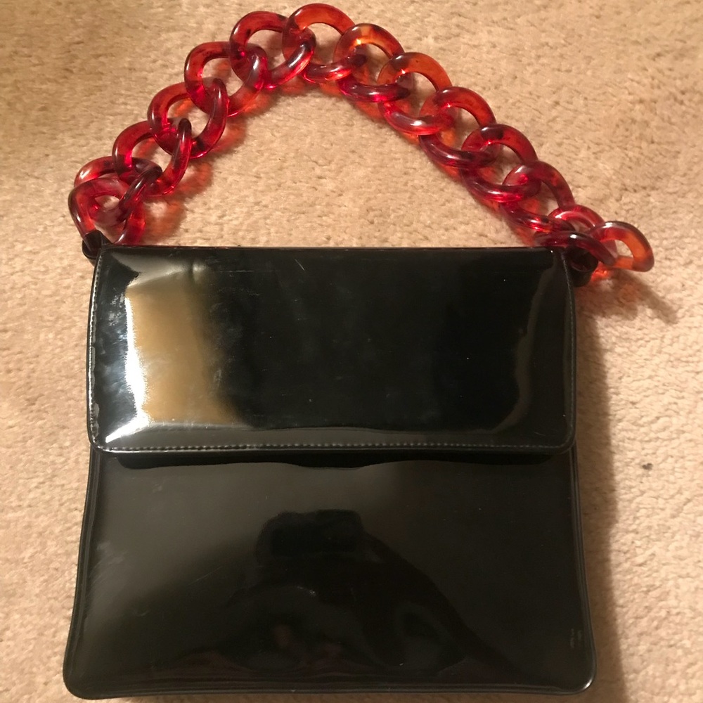 Small black patent leather handbag with link strap